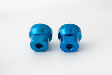 Two round blue anodized aluminum manifold blocks for industrial pneumatic systems. High-precision distribution components with multiple threaded ports for air or fluid control, isolated on a white bac