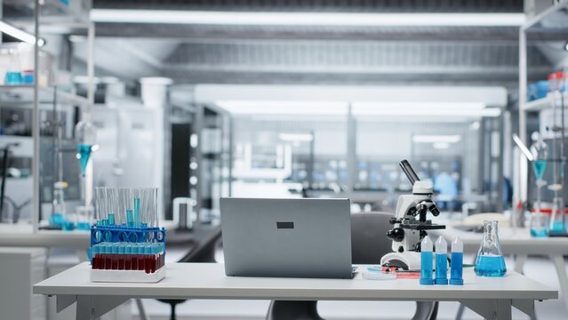 Sterile empty medical laboratory workspace featuring test tube racks on workbench. Clean research facility interior free of contamination with nobody in, ready for scientific work