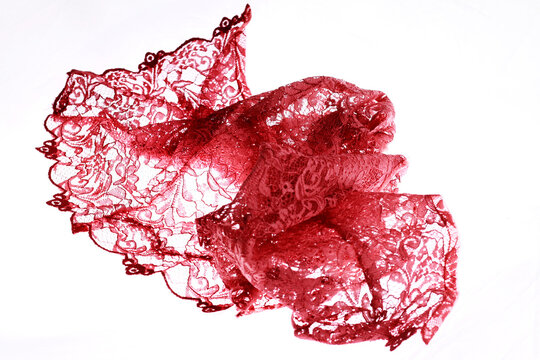 Red brocade fabric texture isolated on white background.