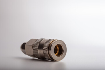 Professional chrome-plated pneumatic quick coupling with hose compression nut, industrial metallic connector for secure air line attachment isolated on white background