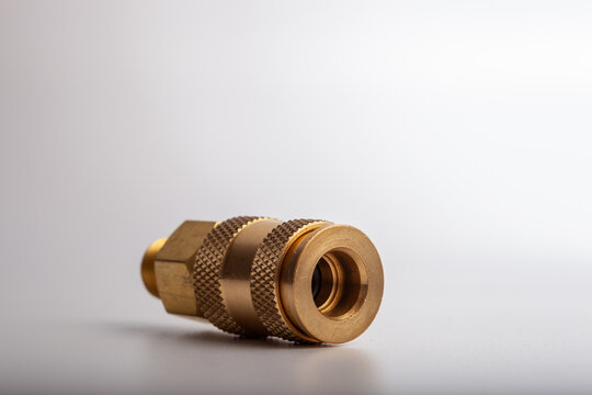 Professional brass quick release pneumatic coupler with male threaded hex base, durable industrial socket connector for air compressor lines isolated on white background.