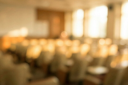 Blurred empty university classroom or conference hall seats.