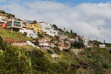 A hillside village on the island of Madeira. The buildings face the Atlantic Ocean © Armands photography