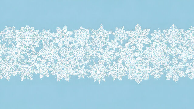 Delicate snowflakes gently falling against a serene blue background, a tranquil winter scene viewed from directly above