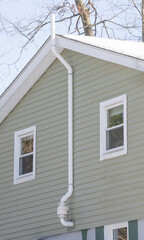 close up on house with radon mitigate system installed