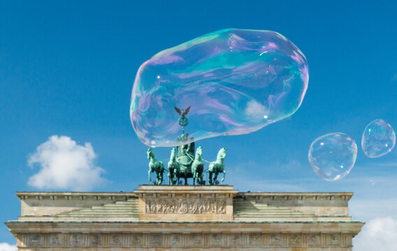 Germany, Berlin.   Large soap bubbles floating above the Brandenberg Gate. 