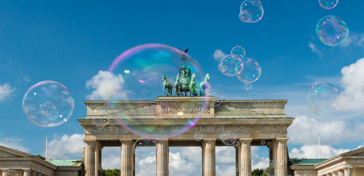 Germany, Berlin.   Large soap bubbles floating above the Brandenberg Gate. 