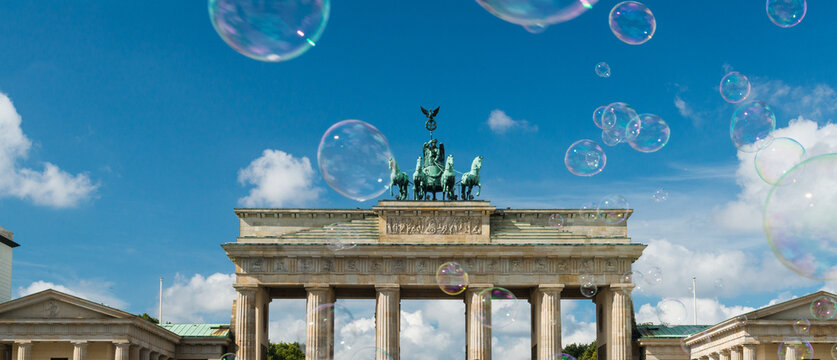 Germany, Berlin.   Large soap bubbles floating above the Brandenberg Gate. 