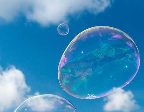 Germany, Berlin.   Large soap bubbles floating above the Brandenberg Gate. 