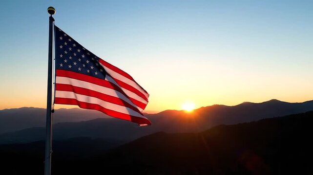 American flag waving in the breeze against a backdrop of mountains and a setting sun