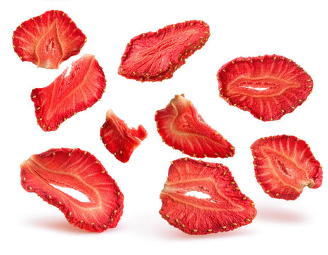 Crispy Dehydrated Strawberry Chips and Slices Falling on White Background
