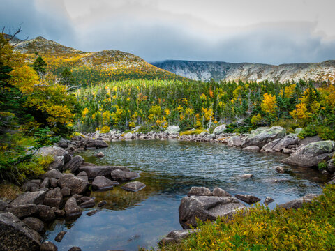 Chimney Pond trail hike at Baxter State Park, Maine, with peak fall foliage on an overcast cloudy day