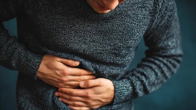 Close view of man clutching abdomen with pain concepthd4k,HD4K,Close up man pressing stomach suffering from abdominal pain,Male experiencing stomach cramps,Adult man feeling stomach problem