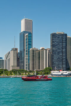The Christopher Wheatley, a Chicago Fire Department Fire Boat, on Lake Michigan in the summer with Chicago skyscrapers in the background. There is copy space in the image.