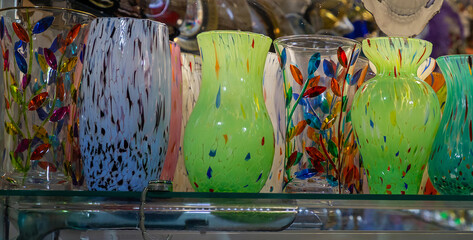 Colorful glass vases on shelf handmade by ancient artists