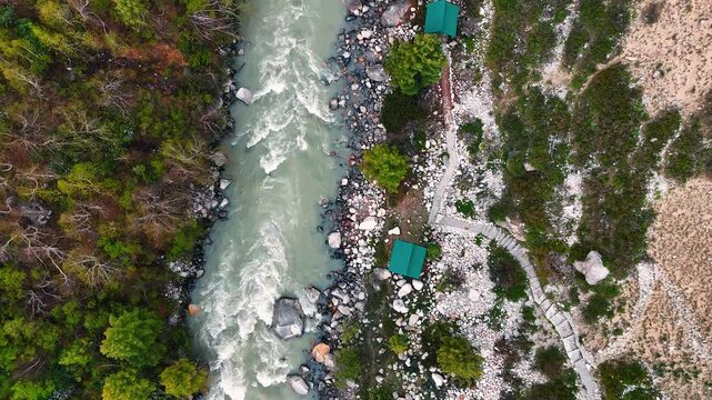 Top Down Drone Shot of Baspa River Flowing Through Forested Valley