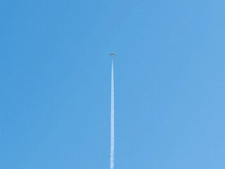 Airplane Trail in Clean Blue Sky with Empty Space