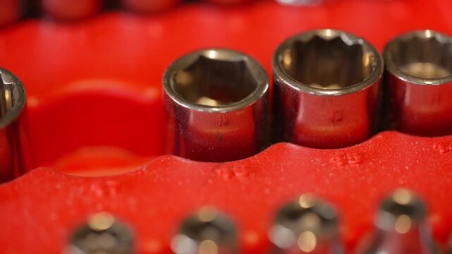 male fingers pluck a size 17mm metric socket from the plastic tool holder
