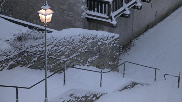 Snow-covered stone stairs near Visby Cathedral in winter, Gotland