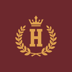 Golden letter H with crown and laurel wreath emblem.