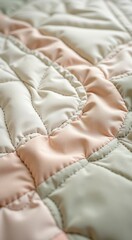Close up of a quilt with a pink and white design