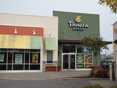 Nepean, ON, Canada-July 13,2025: A wide exterior view of the "Panera Bread restaurant" entrance and facade at 320 W Hunt Club Rd.