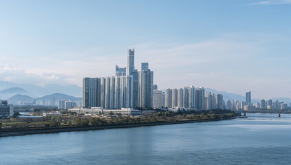 Obraz premium 湾岸高層ビル群の背後に遠くの山並みが連なる自然と都市が共存するスカイライン