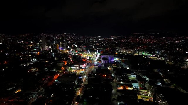 Beautiful aerial night view of Tegucigalpa, capital of Honduras and Comayaguela, surrounded by mountains and the city glowing across the urban valley