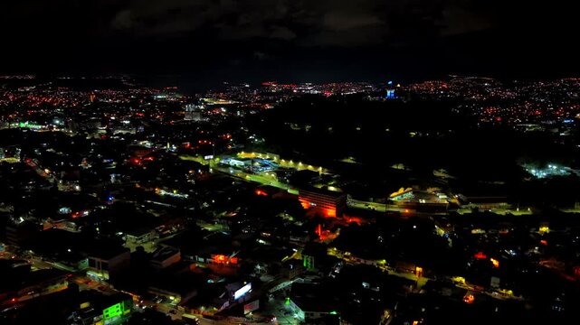 Beautiful aerial night view of Tegucigalpa, capital of Honduras and Comayaguela, surrounded by mountains and the city glowing across the urban valley