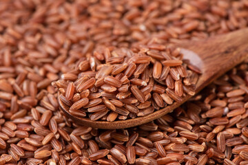 closeup of raw red rice grains background