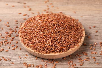 closeup of raw red rice grains on table
