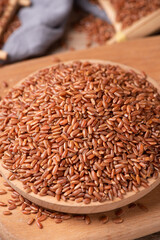 closeup of raw red rice grains on table