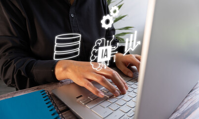 I work with artificial intelligence. Business person working on their computer with AI icons, database graphics, and gears.