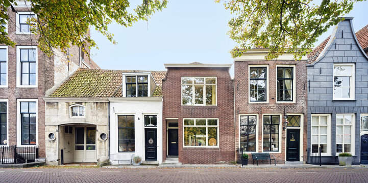 Authentic facade of historic houses in Zierikzee, Netherlands. Featuring diverse architectural styles, brickwork, and traditional Dutch gables