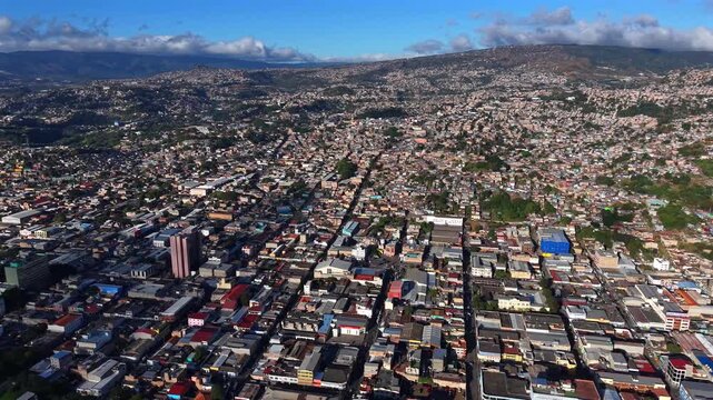 Beautiful aerial night view of Tegucigalpa, capital of Honduras and Comayaguela, surrounded by mountains and the city glowing across the urban valley