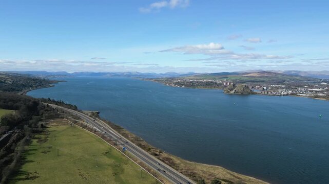 High altitude aerial shot showing the M8 motorway running parallel to the River Clyde under a clear blue sky. Perfect for travel, infrastructure, and Scottish landscape projects.