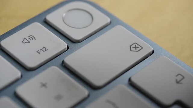 Extreme close up of a finger performing a long press on the backspace key of a sleek keyboard. Ideal for tech, editing, and error correction concepts.