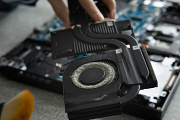 Repairing a Laptop by Removing the Graphics Card and Cleaning Dust From the Fan © Liana