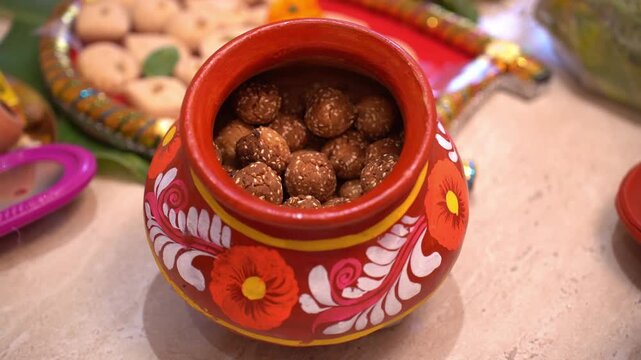 Til-er Ladoo are artisanal sesame treats prepared during the harvest season and traditionally shared during the Poush Parbon festivities