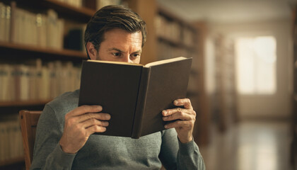 Man reading book in elegant library. Perfect for educational, reading, academic, literature, knowledge, studying, intelligence, and library concepts.