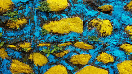 Abstract Colorful Painted Stone Wall Texture with Yellow and Blue Accents