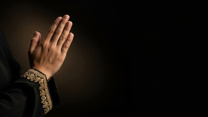 Hands in prayer with gold embroidered cuffs