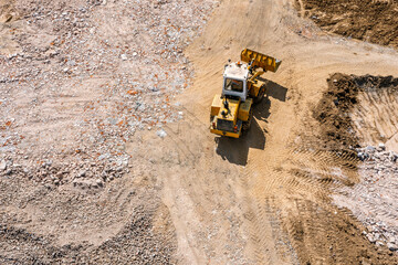 large yellow wheel loader on construction site. powerful modern machinery for earthworks. aerial view.