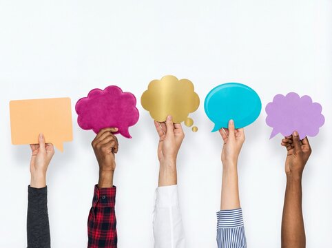Diverse hands holding colorful empty speech bubbles for communication concepts on white background