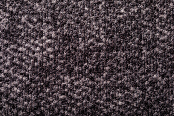 Fototapeta premium Close-up of a dark textured carpet. Perfect for backgrounds or interior design projects. Offers comfort, warmth and a se