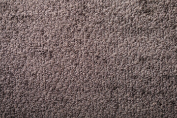Detailed shot of a brown carpet surface, suitable for backgrounds, textures, or design applications. High-quality and ve
