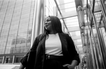 Businesswoman walking in modern city with analogous film grain effect