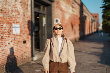 Fototapeta premium Woman tourist Visiting in Hakodate, happy Traveler sightseeing Kanemori Red Brick Warehouse in spring season. landmark and popular for attractions in Hokkaido, Japan. Travel and Vacation concept