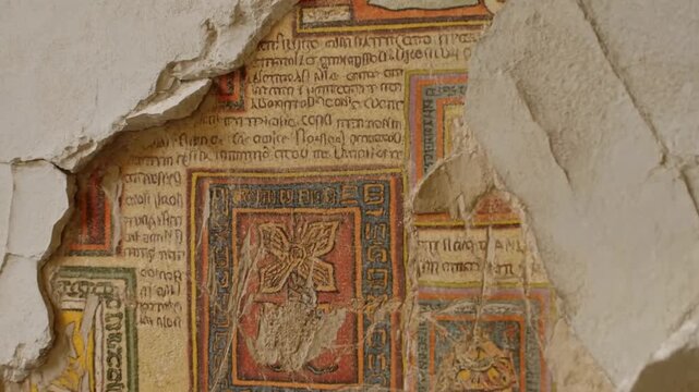 Cracked library wall where fallen plaster reveals fragments of a vibrant forbidden fresco with arcane symbols and text, historical censorship and discovery atmosphere
