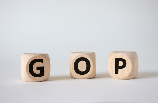 GOP - Gross Operating Profit symbol. Concept word GOP on wooden cubes. Beautiful white background. Business and GOP concept. Copy space.